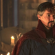 Benedict Cumberbatch's Doctor Strange stands in concerned reflection, in a room lit by a series of candles.